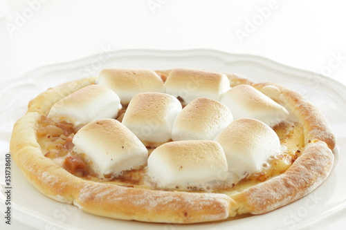 Marshmallow and sugar pizza on dish for sweet food