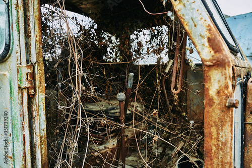 Old abandoned rusty broken tractor. Tractor in a landfill.