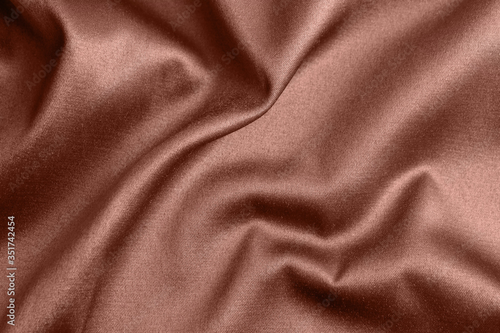 Obraz premium Textured rose gold fabric as background, closeup view