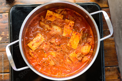 Kimchi soup with tofu cooking in hot pot, Korean food (Kimchi Jjigae), Top view