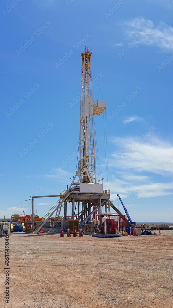 Vaca Muerta, Argentina, December 23, 2014: Extraction of unconventional oil. Battery of pumping trucks for hydraulic fracturing (Fracking).