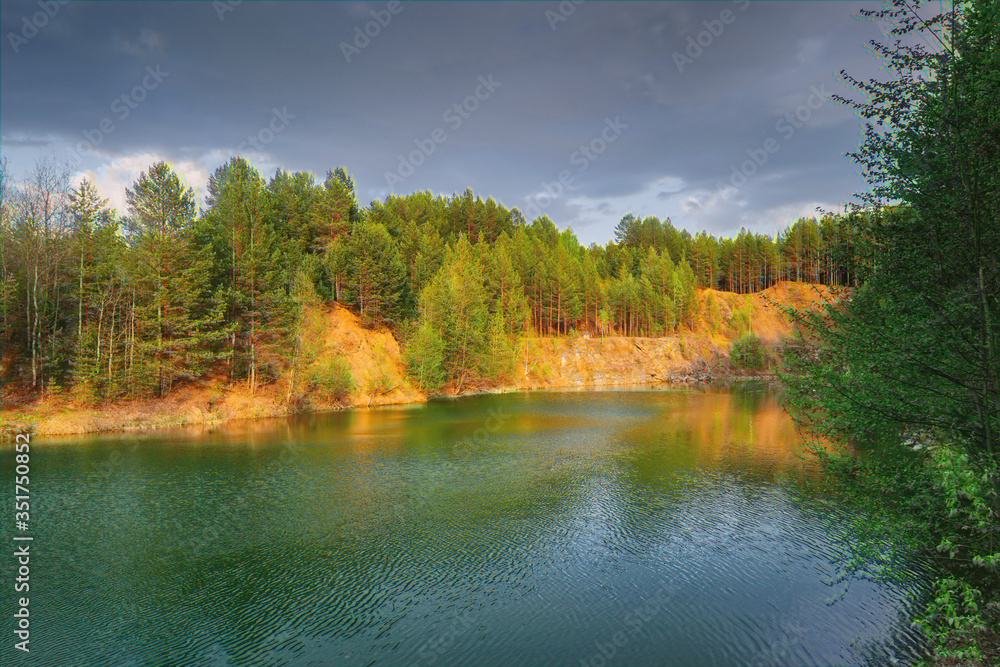Obraz premium Mountain lake surrounded by forest. Spring landscape.