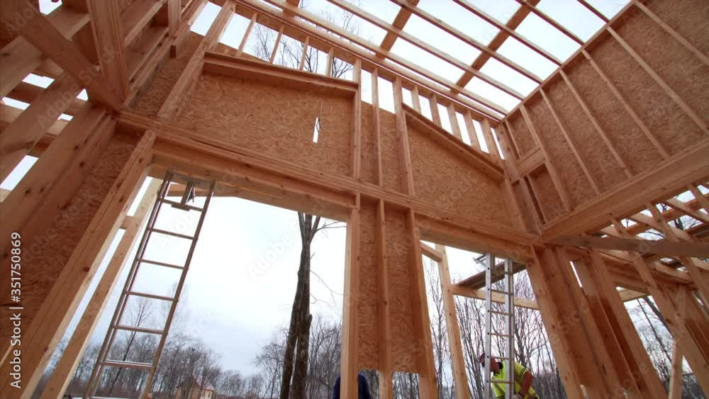 Timelapse from inside of new frame house, view from below of builders covering the house with plywoods. Frame house under construction Timelapse from inside of new frame house, view from below of builders covering the house with plywoods. Frame house under construction