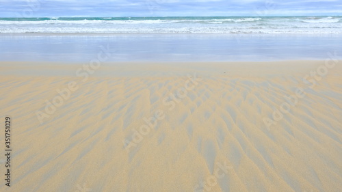 yellow blue sand and water texture as abstract background. Sand triangle patterns.Summer holiday while traveling around Australia.