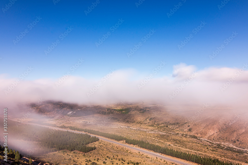 Long exposure shot from above of the fog in the mountains and valley in Esquel, Patagonia, Argentina Long exposure shot from above of the fog in the mountains and valley in Esquel, Patagonia, Argentina