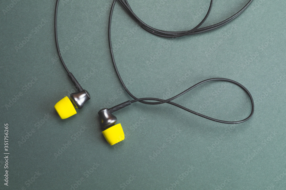 Earphones with yellow ear cushions. in-ear headphones. audio equipment Earphones with yellow ear cushions. in-ear headphones. audio equipment