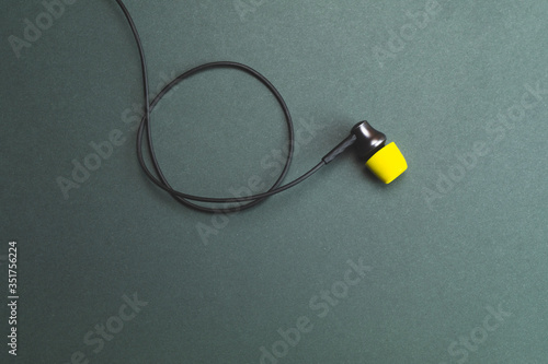 Earphone with yellow ear cushions. in-ear headphones. audio equipment