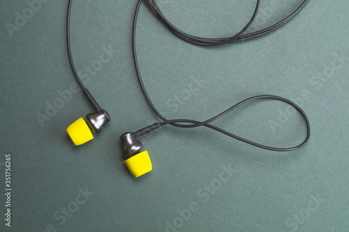 Earphones with yellow ear cushions. in-ear headphones. audio equipment