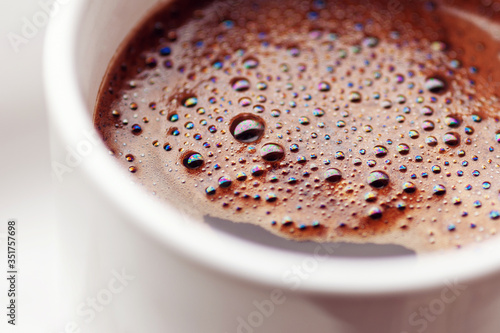 Black coffee in white cup, close up © Enso