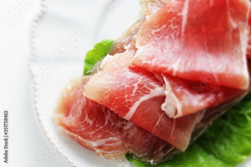 sliced ham on plate with copy space for gourmet