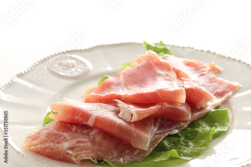 sliced ham on plate with copy space for gourmet