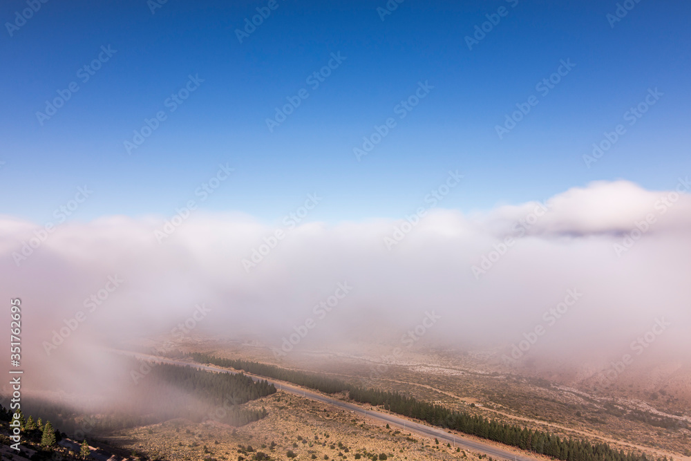 Long exposure shot from above of the fog in the mountains and valley in Esquel, Patagonia, Argentina