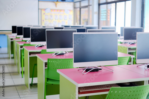 Wallpaper Mural Empty computer room  for student.Classroom with rows desks chairs Empty class room, no school no student,only online learning, Distance Learning Online Education home School ,Back to school concept. Torontodigital.ca