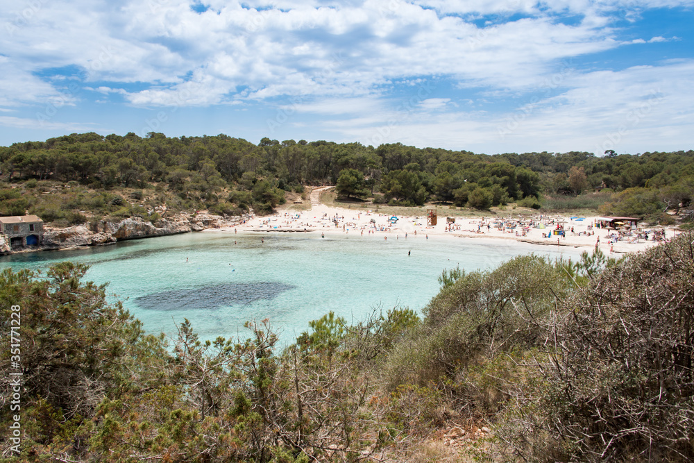 Beach with people and sea landscape in Santanyi, Majorca