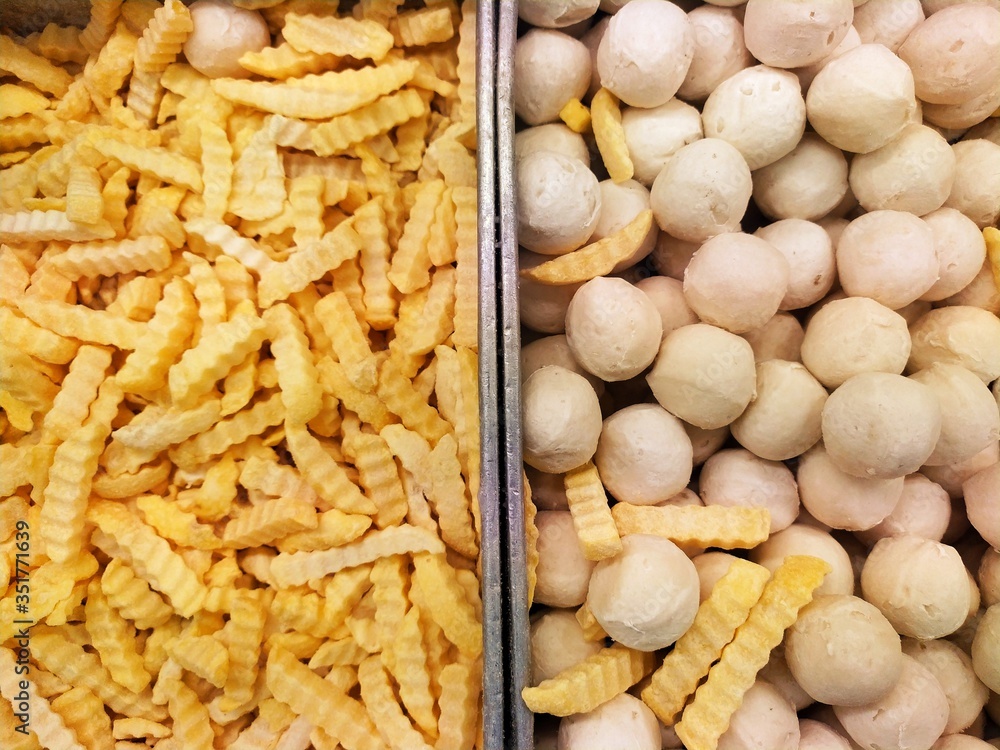 Full frame of fast food frozen french fries and meat ball at food store