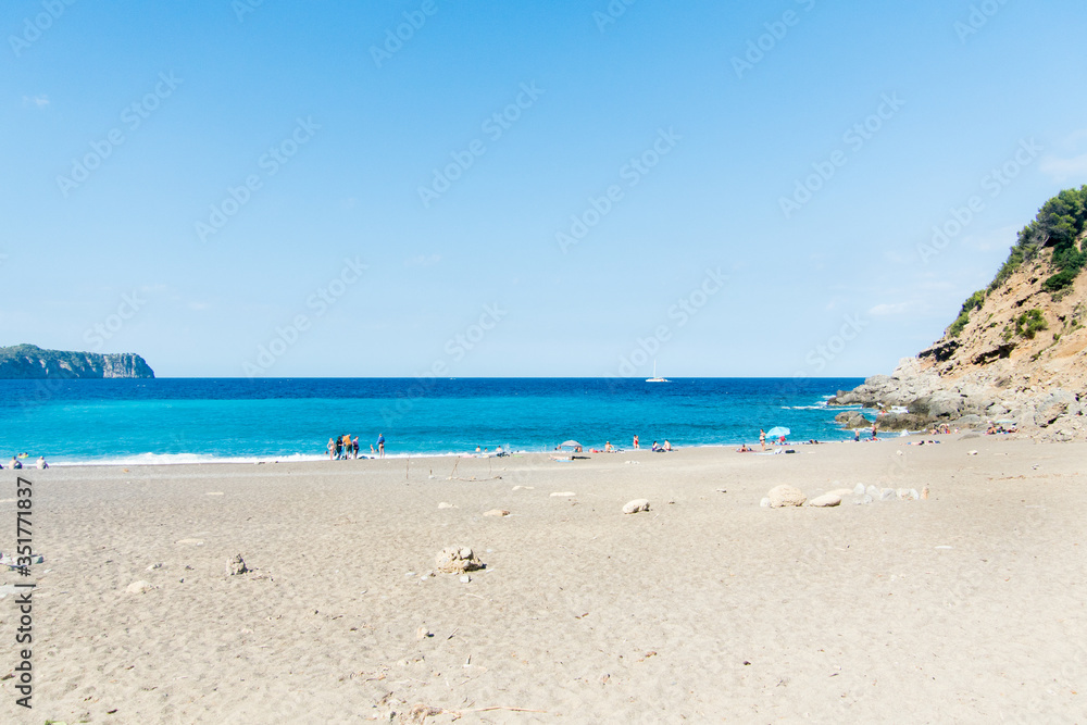 Beach with people and sea landscape in Coll Baix, Alcudia, Majorca