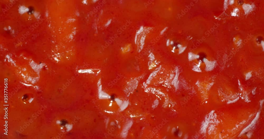 Tomato sauce with spices is boiling with air bubbles. Tomato sauce with spices is boiling with air bubbles.