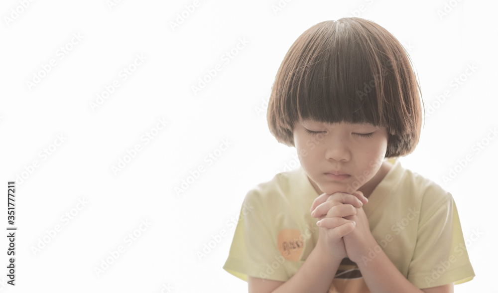 girl praying in morning, hands folded in prayer
