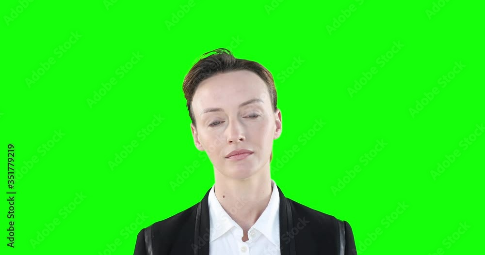 woman looking at camera on green background woman looking at camera on green background