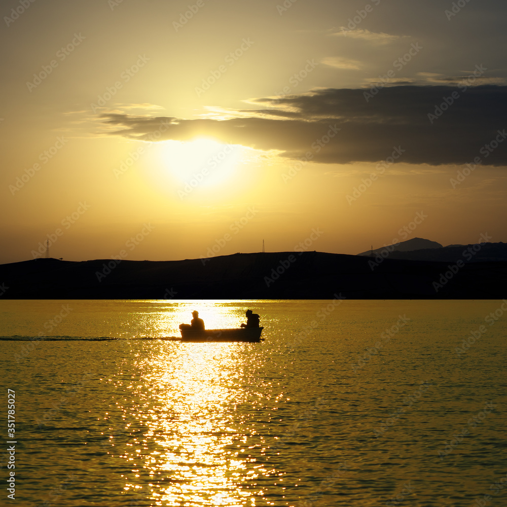 Sea Of Sicily At Golden Sunset, Silhouette Boat And Two Fishermen
