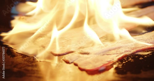 The bacon burning in a flame of fire. photo