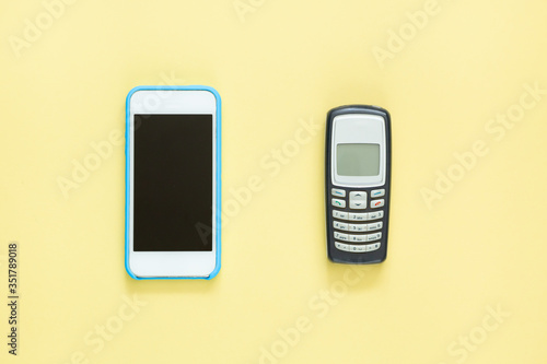 Smartphone and push-button telephone. Modern phone and old phone
