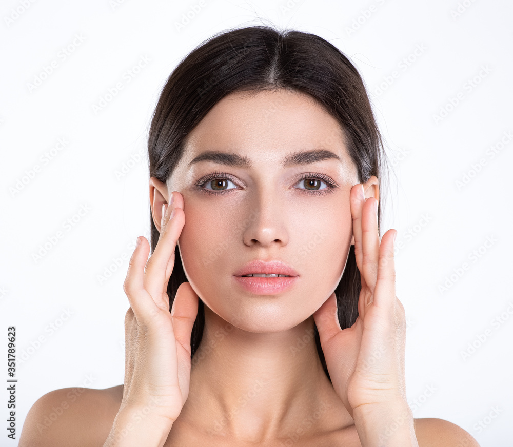 Portrait of beautiful young brunette woman with clean face. Beautiful face of young adult woman with clean fresh skin - isolated on white. Front portrait of woman with beauty face. .Beauty concept Portrait of beautiful young brunette woman with clean face. Beautiful face of young adult woman with clean fresh skin - isolated on white. Front portrait of woman with beauty face. .Beauty concept