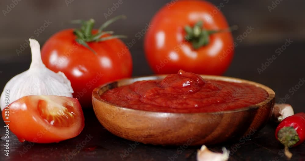 Tomato sauce with spices on the plate slowly rotates. Tomato sauce with spices on the plate slowly rotates.