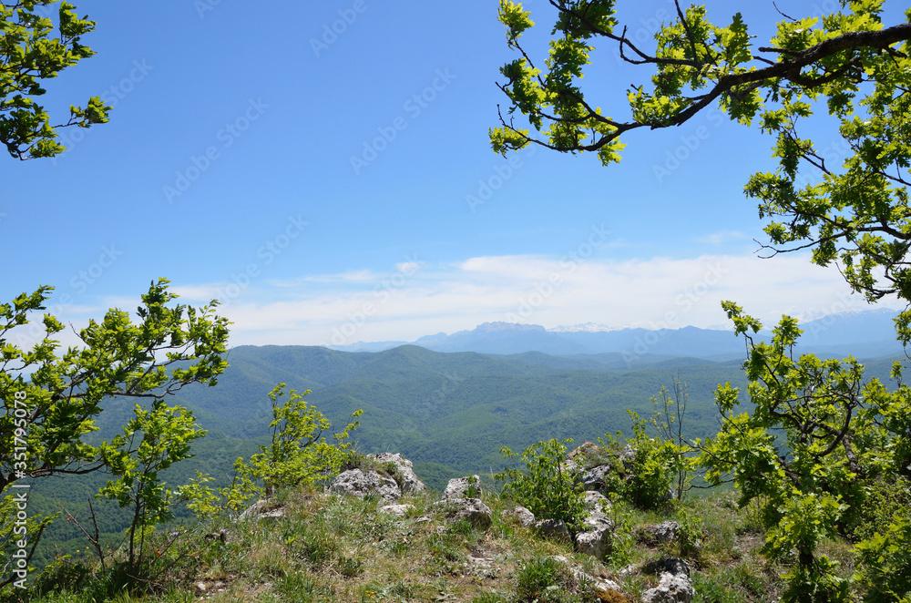 Adygea, mountain landscape in spring. In the background of the main Caucasian ridge
