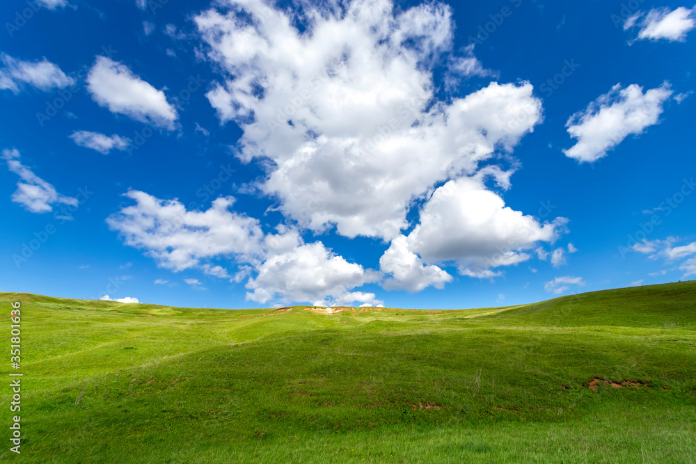 Green hills against the blue sky with clouds. Beautiful screensaver. Green hills against the blue sky with clouds. Beautiful screensaver.