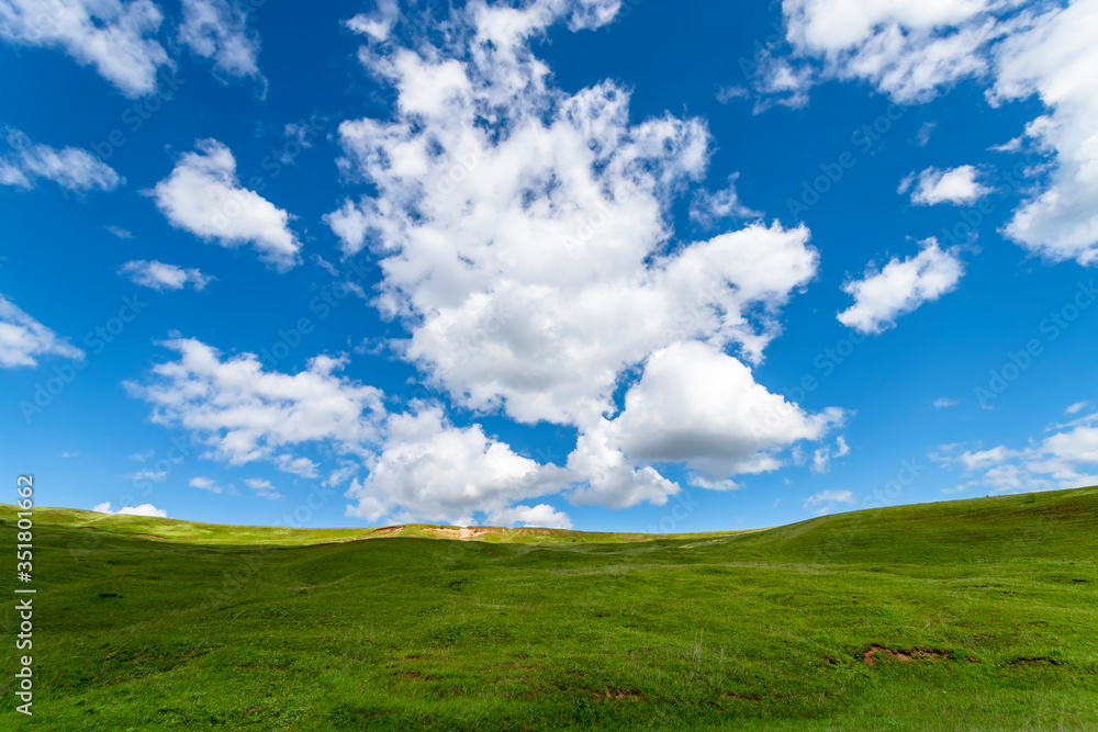 Green hills against the blue sky with clouds. Beautiful screensaver. Green hills against the blue sky with clouds. Beautiful screensaver.