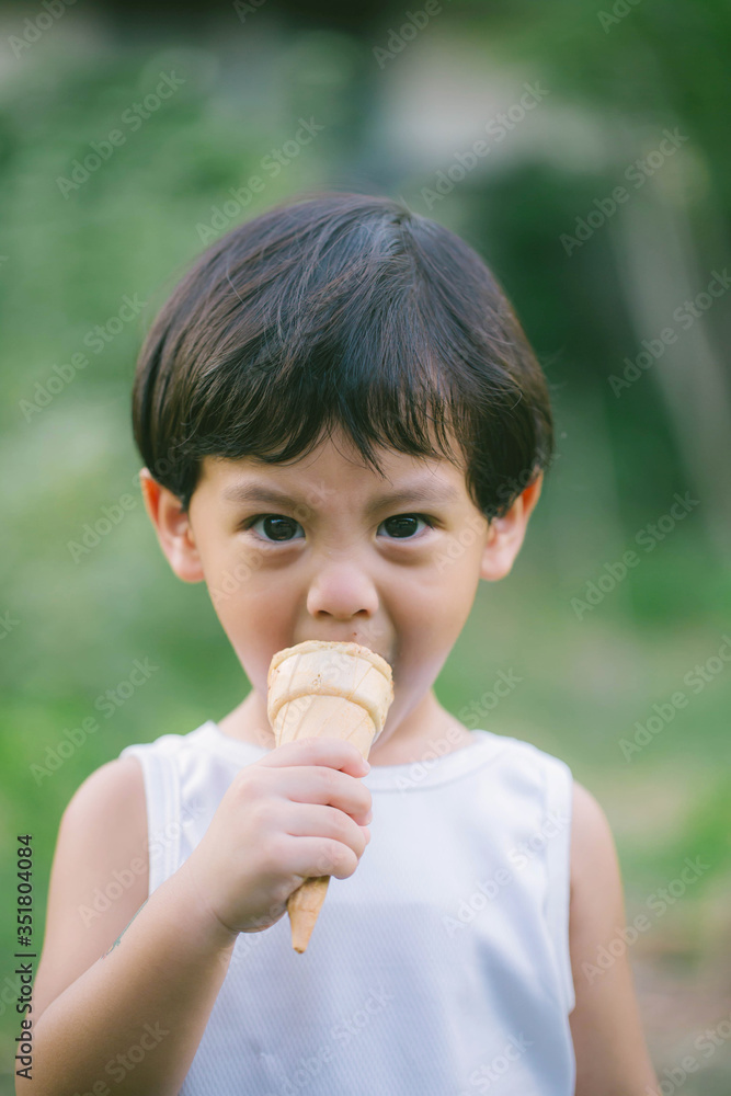 Asia boy he mouth aftertaste from eating chocolate ice cream or chocolate dessert. A sweet-toothed child eat chocolate. Kid with dirty face eating ice cream. Cute toddler boy eating icecream. Asia boy he mouth aftertaste from eating chocolate ice cream or chocolate dessert. A sweet-toothed child eat chocolate. Kid with dirty face eating ice cream. Cute toddler boy eating icecream.