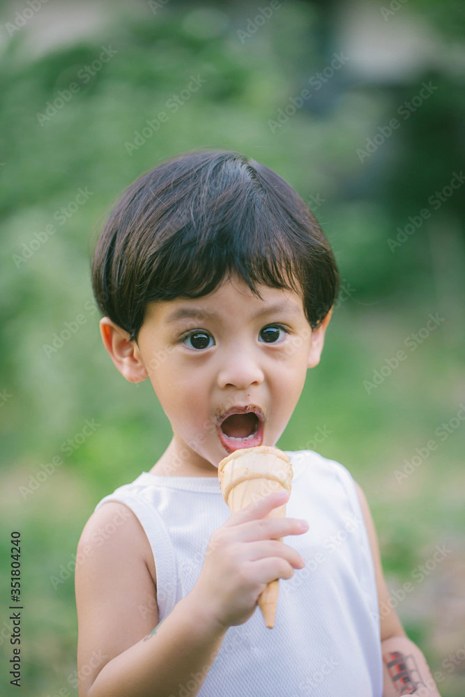Asia boy he mouth aftertaste from eating chocolate ice cream or chocolate dessert. A sweet-toothed child eat chocolate. Kid with dirty face eating ice cream. Cute toddler boy eating icecream. Asia boy he mouth aftertaste from eating chocolate ice cream or chocolate dessert. A sweet-toothed child eat chocolate. Kid with dirty face eating ice cream. Cute toddler boy eating icecream.