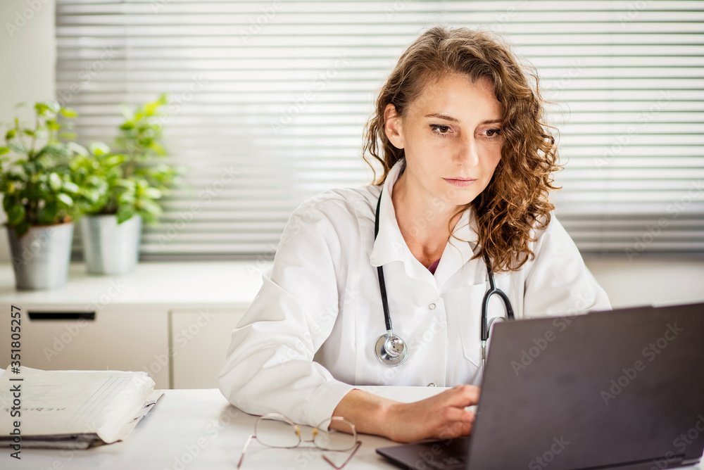 portrait of female doctor working on laptop telemedicine concept portrait of female doctor working on laptop telemedicine concept