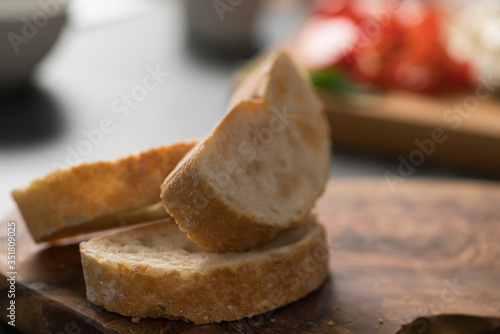 Slices of ciabatta bread on olive board