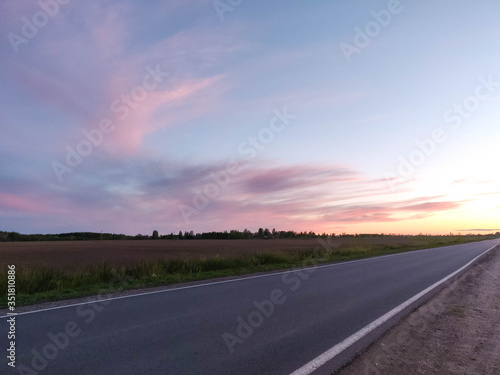 pink sunset over the field and road