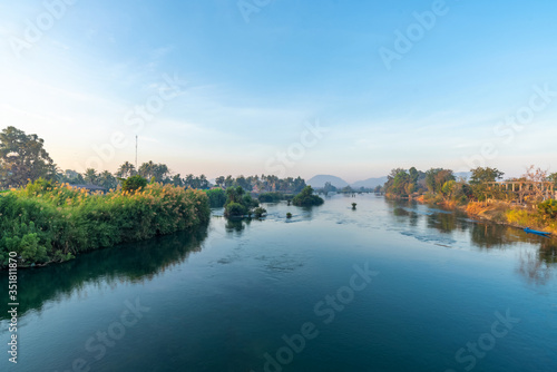 Beautiful landscape view of sunrise and old wooden boat drop nearly the river in front of guest house from Don Det the famous place for tourist to relaxing at Siphondon island, Laos.