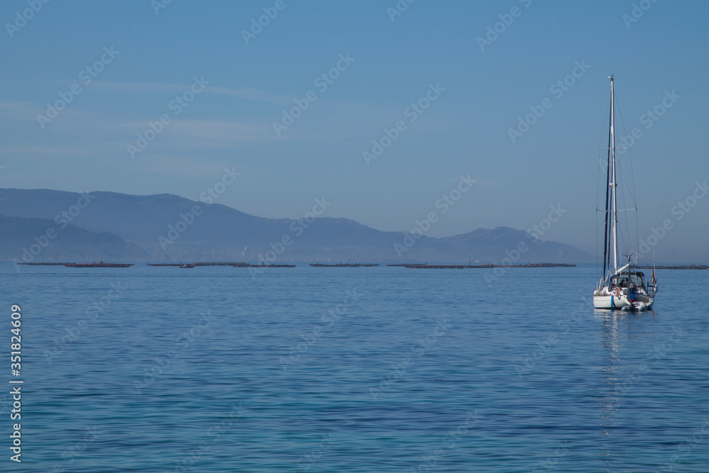 sailboat sailing in the calm waters of the sea sailboat sailing in the calm waters of the sea