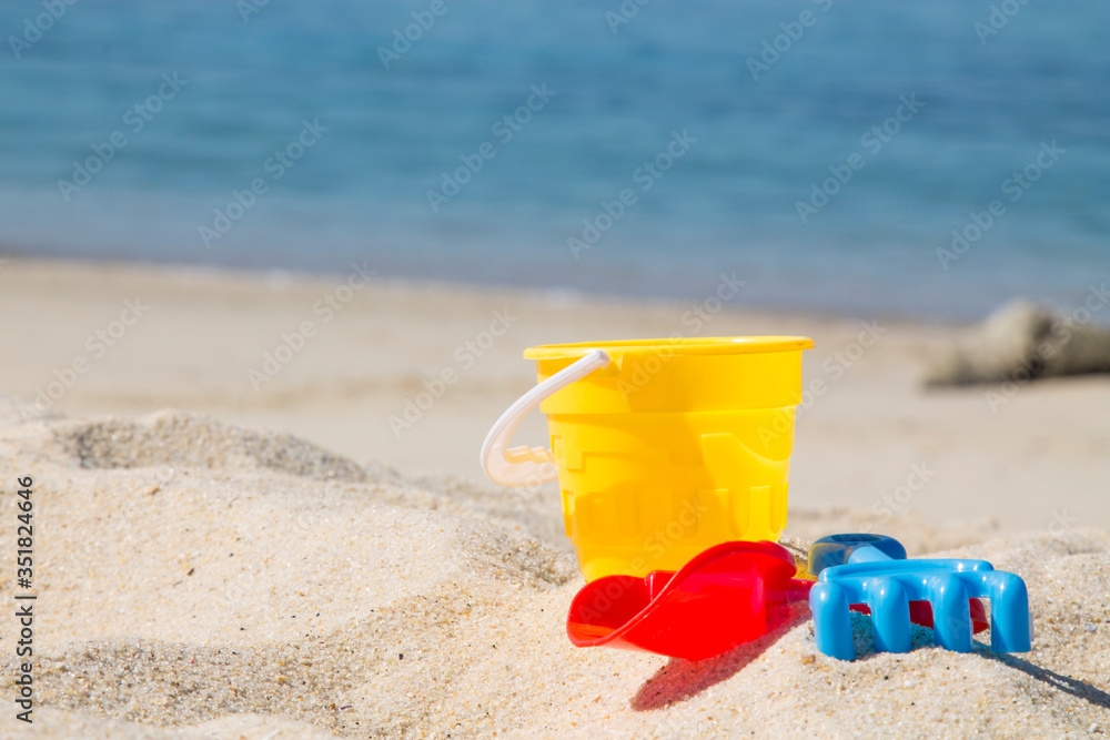 bucket, shovel, rake on the beach sand bucket, shovel, rake on the beach sand