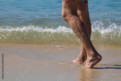 man's legs by the beach shore © tetxu