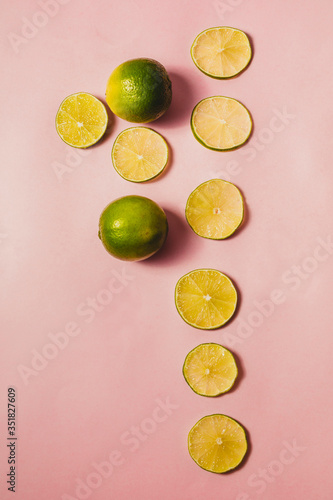Refreshing citrus, freshly cut lime on a pink background.