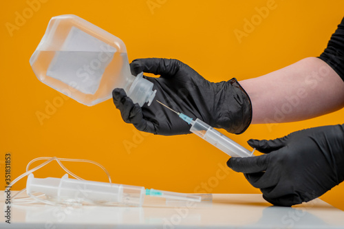 Hands in black rubber glove...