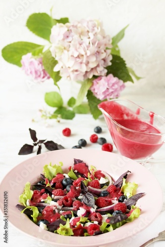 homemade berry vinaigrette. Salad with berries with vinaigrette. Vegetarian salad with raspberries and blueberries.