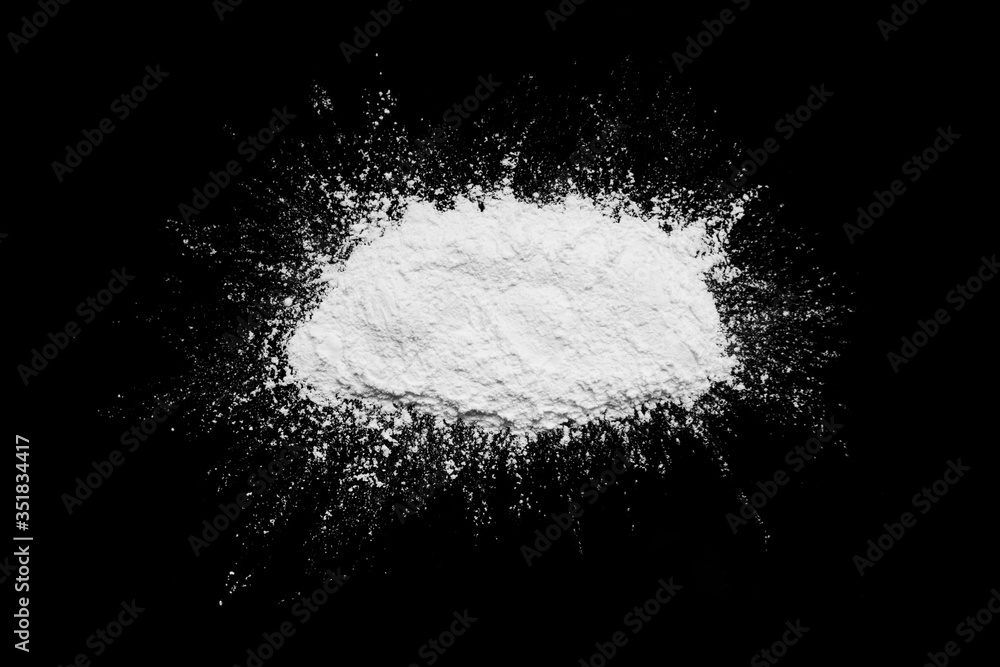 White powder isolated on the black background. White powder isolated on the black background.