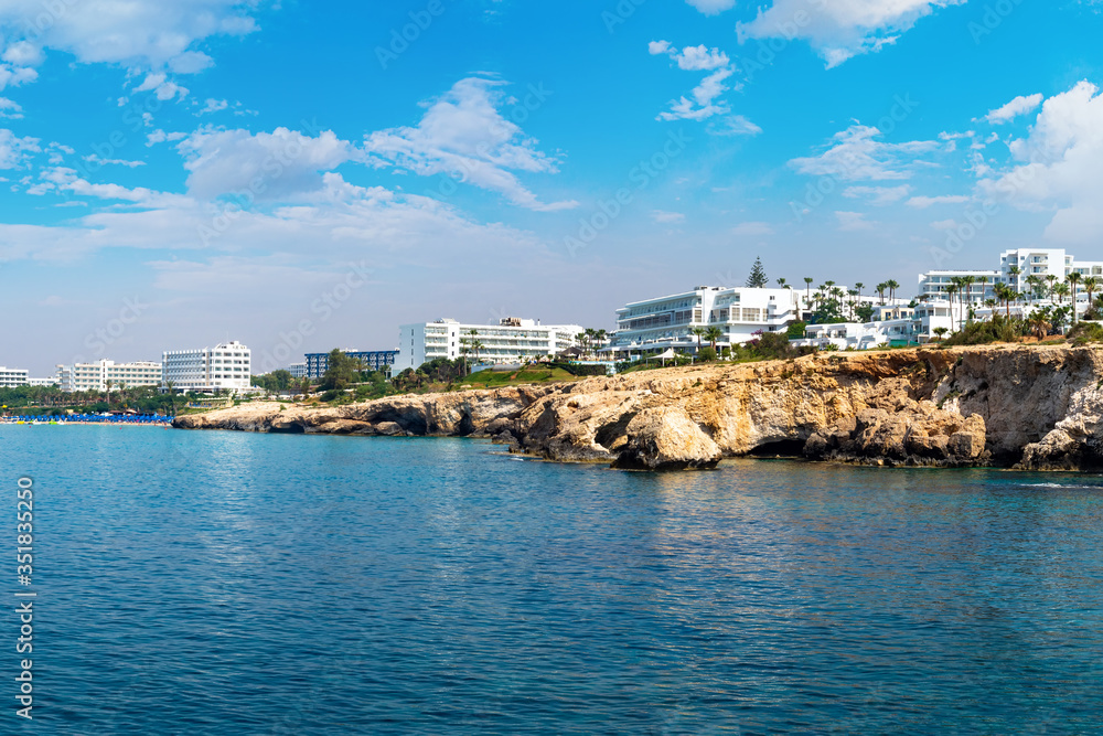Cyprus beach. Ayia Napa Resort. Hotels near beaches of Cyprus. Rocky coast of Ayia Napa resort. Landscapes of the Cyprus coast. Holidays in the Mediterranean. Hotel buildings near the shore