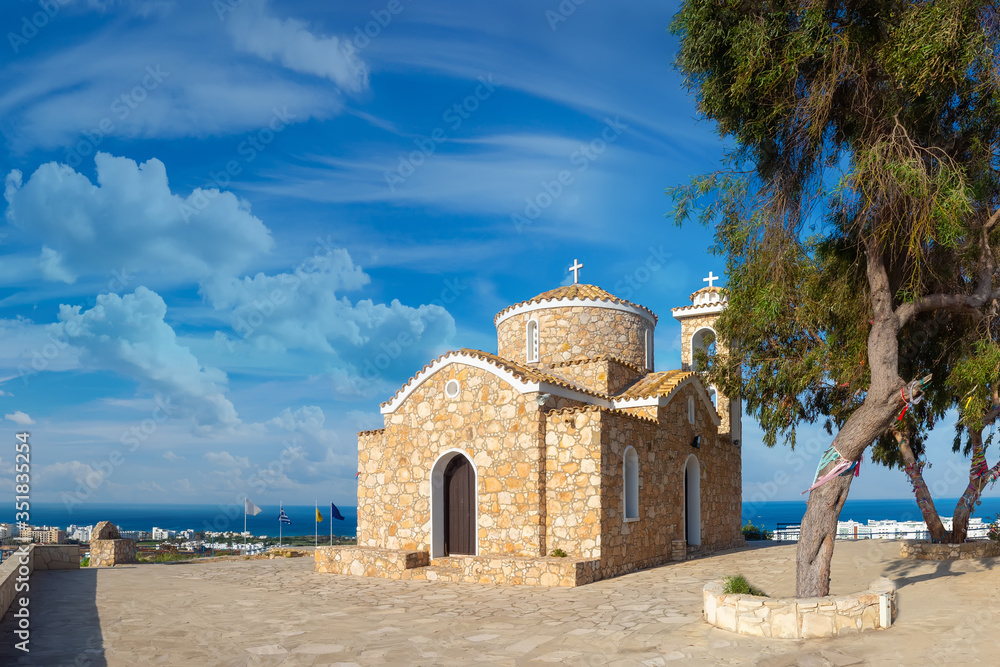 Cyprus beach. Protaras. Church of Elijah the Prophet. Stone temple on background of blue sky. Church of Elijah Prophet in Cyprus. Sights of city of Protoras. Cruise to Cyprus. Protaras Tourism.