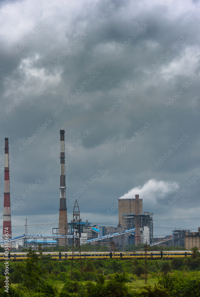 View of Cooling Tower and Chimneys with Moody Sky.