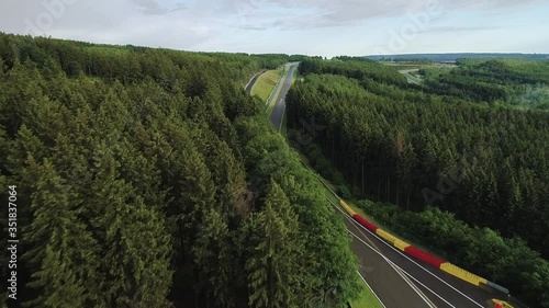 Low flyover trees as cars drive on Spa circuit, Belgium photo