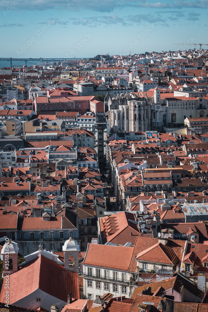view of the center of lisbon, the elevator of santa justa and the carmo church between the buildings from theviewpoint of san jorge view of the center of lisbon, the elevator of santa justa and the carmo church between the buildings from theviewpoint of san jorge