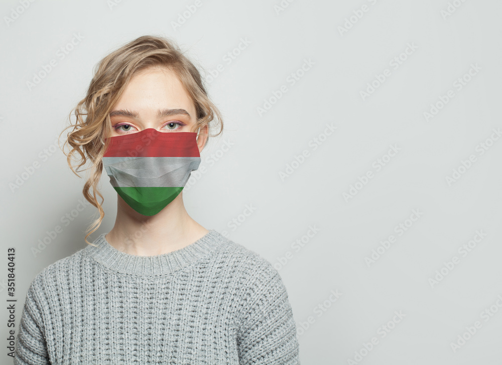 Young woman wearing a face mask with flag. Flu epidemic and virus protection concept Young woman wearing a face mask with flag. Flu epidemic and virus protection concept